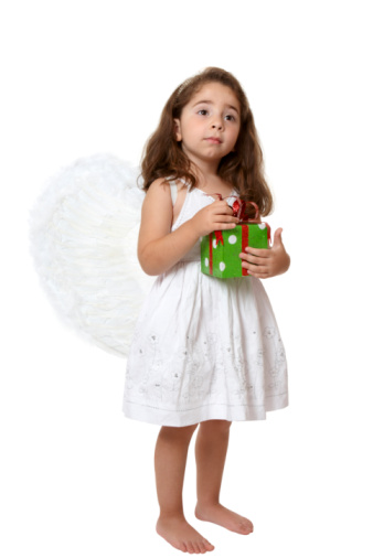 Ideas and fantasies. Cute little girl, child in image of angel sitting with smile isolated over white studio background. Concept of childhood, imagination, fantasy, fashion and beauty, holidays. Body