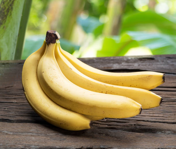 istock Banana bunch on the wooden table. 920332172