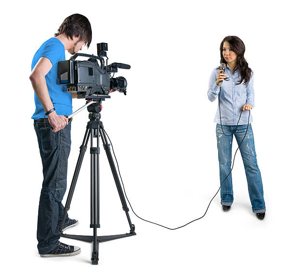 Happy young woman giving an interview in a studio, smiling and gesturing with his hands while she is talking