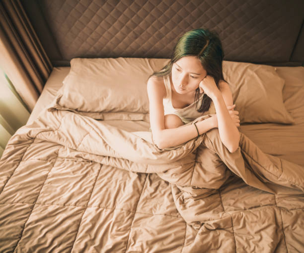 istock Asian woman suffering from depression on bed 920342534