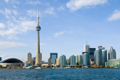 Toronto, Canada - May 13, 2023: The CN Tower stands tall against a backdrop of modern city buildings. The downtown is a tourist attraction