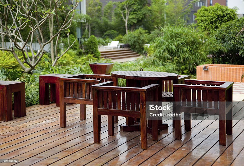 House patio with table and chairs House patio with wooden table and chairs Deck Chair Stock Photo