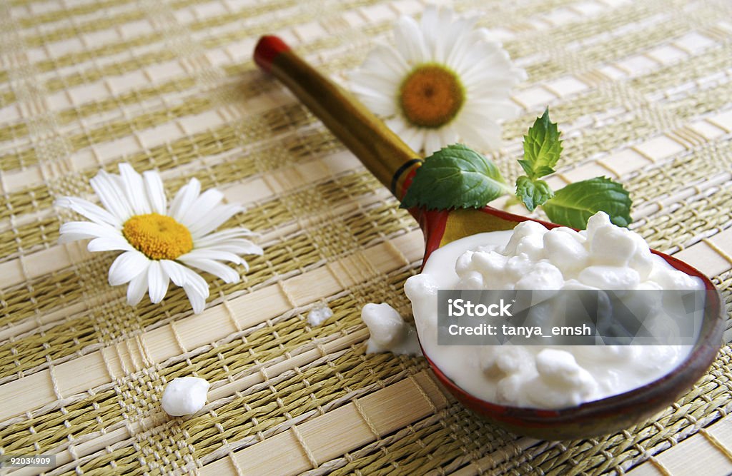 Wooden spoon with cottage cheese  Bedding Stock Photo