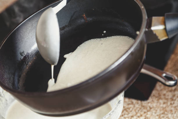 istock liquid dough is poured onto frying pan 920350910