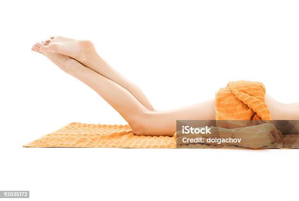 Long Legs Of Relaxed Lady With Orange Towel Stock Photo - Download Image Now - Adult, Balance, Barefoot