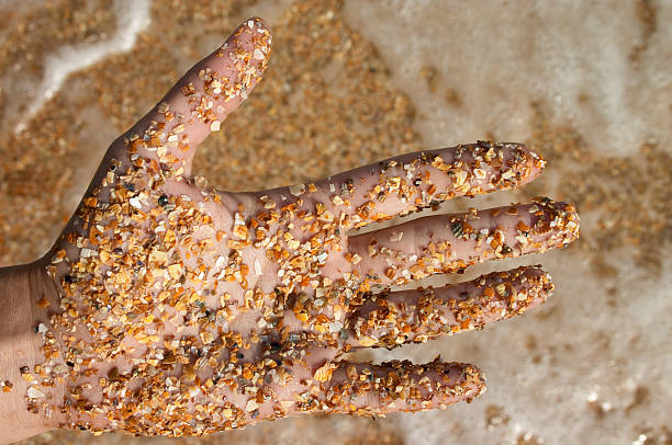 istock hand in sasnd against of sea beach 92035294