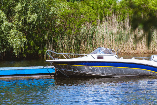 istock Modern motor boat stand dock in bay 920356070