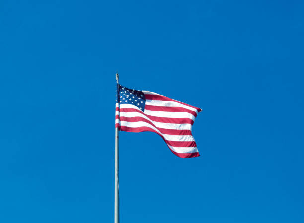 istock USA flag on the clear blue sky background. 920356274
