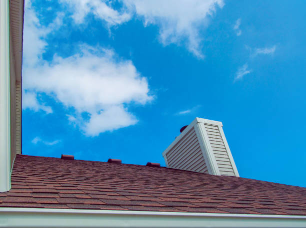istock Dark red roof with chimney pipe on blue sky background. 920356340
