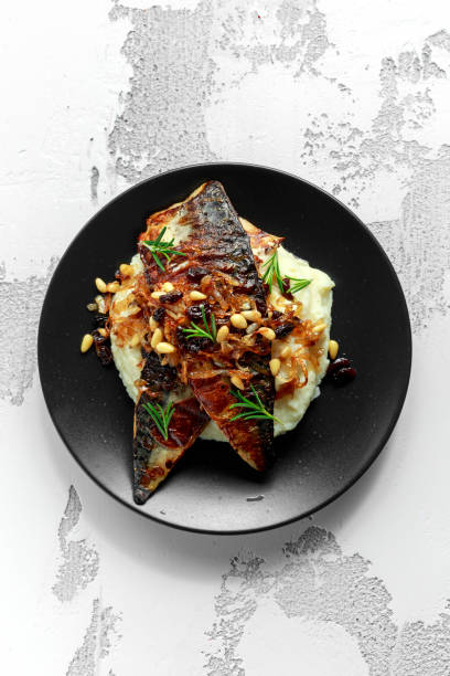 istock Sicilian style mackerel on cauliflower puree with caramelized onions, pine nuts 920356540