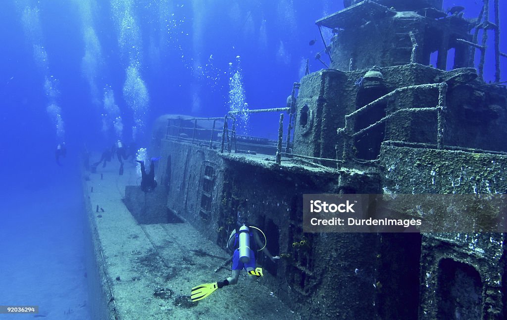 Scuba divers explore a wreck  Wreck Diving Stock Photo