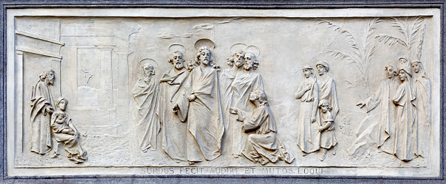 Turin - The relief of jesus and rich young ruler on the facade of church Basilica Maria Ausiliatrice by Emilio Spalla (1897 - 1971).
