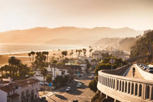 Sunset in Santa Monica, view on beach, pacific ocean and highway, soft focus and low contrast due to rimlight, monochrome vintage