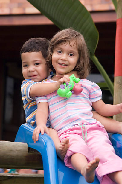 istock A young boy and girl on a slide 92037134