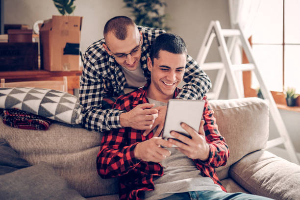 istock Gay couple watching video on digital tablet 920375414