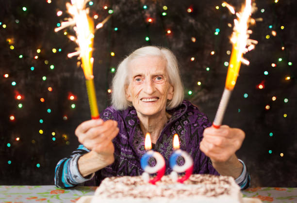 istock Happy grandma celebrating 99th birthday with firework 920375700
