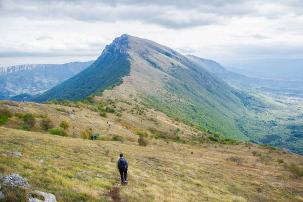istock Young caucasian man walking on high mountain. 920377756