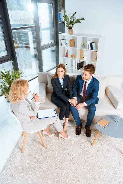 istock young couple and psychologist 920379044