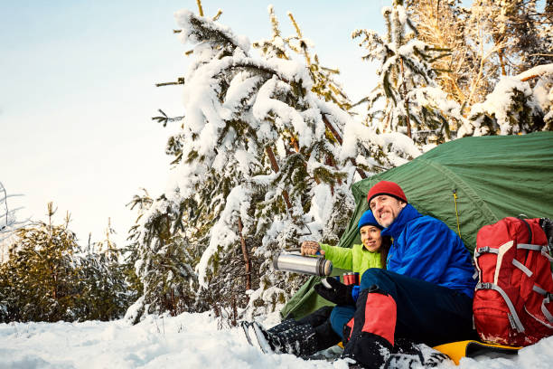 istock Walk through the winter forest with a backpack and tent. 920381426