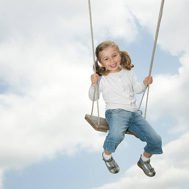 Happy girl swinging