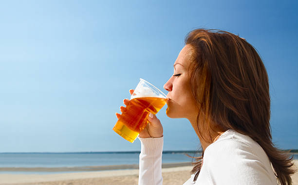 istock Woman sipping beach on a cool beach 92038173