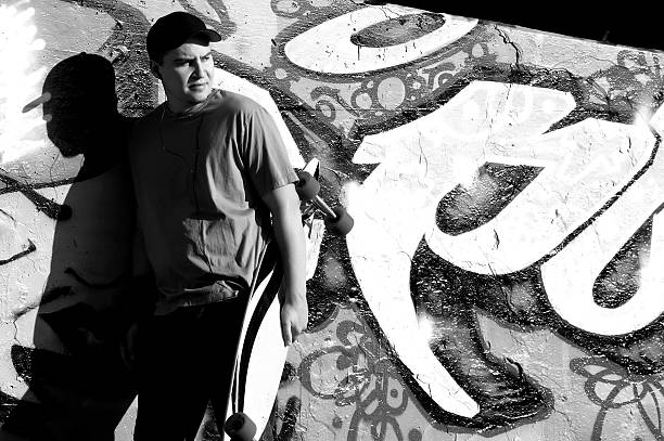 istock Man Against Grafitti Wall - Holding Longboard 92038491