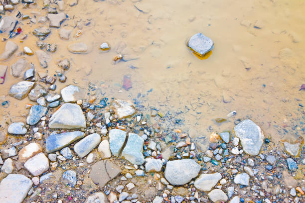 istock Puddle on rocky ground with water and stones 920392512