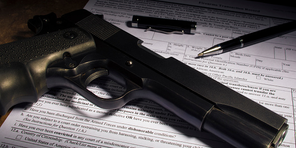 Pistol and paperwork for a transfer of the gun and dishonorable discharge clause obvious