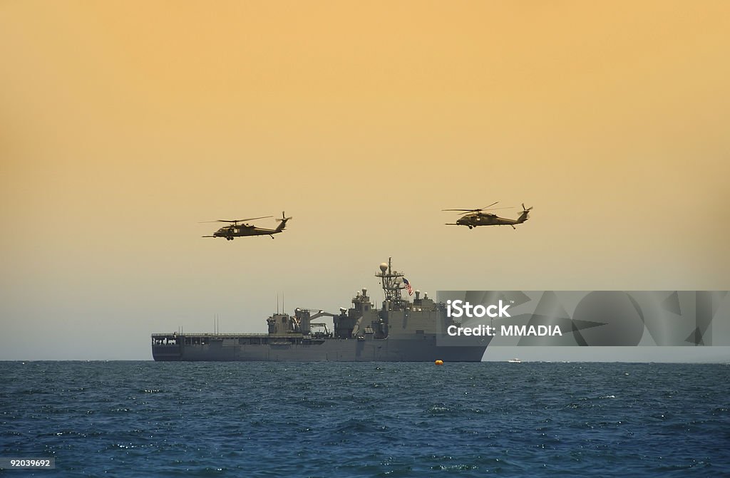 Helicopeters hovering over navy ship  Military Ship Stock Photo