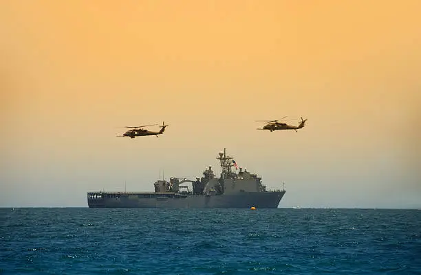 Photo of Helicopeters hovering over navy ship