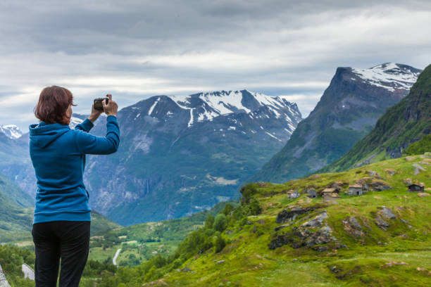 istock Tourist taking photo in mountains Norway 920399432