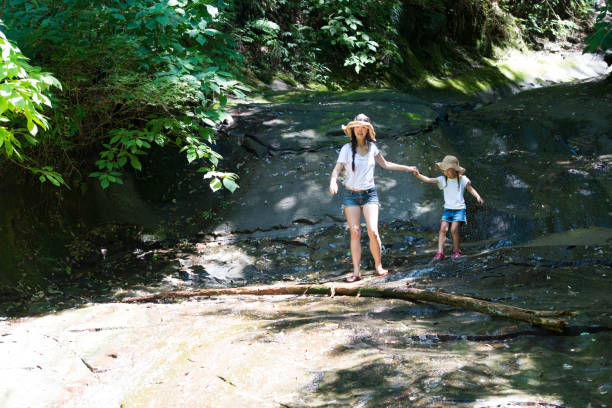 istock Mother and daughter playing in mountain stream 920402298