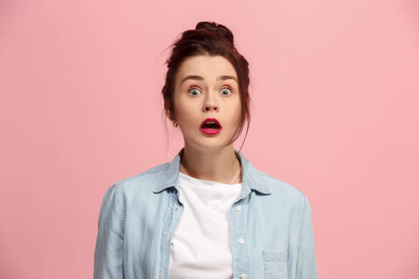 istock Beautiful woman looking suprised isolated on pink 920402350