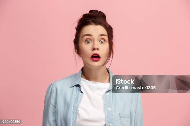 Beautiful Woman Looking Suprised Isolated On Pink Stock Photo - Download Image Now - Human Face, Shock, Facial Expression