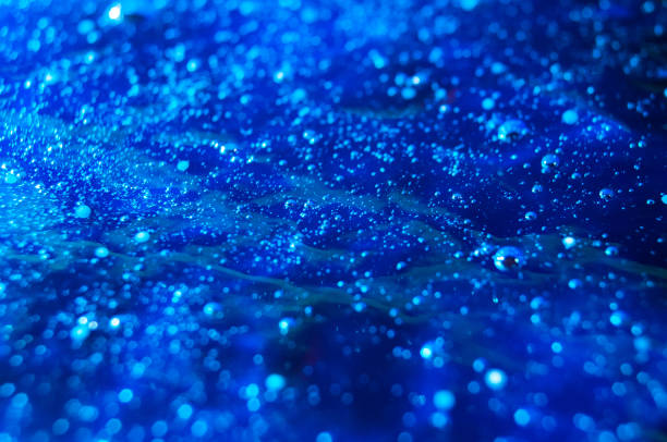 istock Drops of water on a blue glass 920403328