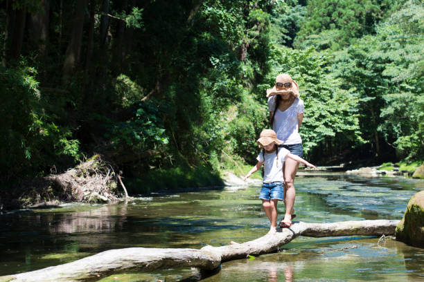 istock Mother and daughter playing in mountain stream 920403478