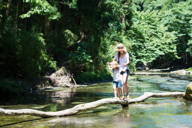 istock Mother and daughter playing in mountain stream 920403480