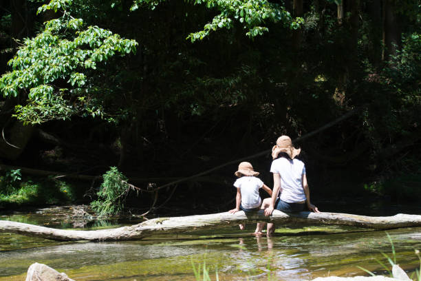 istock Mother and daughter playing in mountain stream 920405740