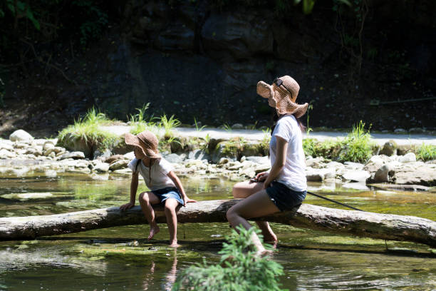 istock Mother and daughter playing in mountain stream 920406154
