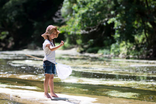 istock Little girl playing on a stream 920408688