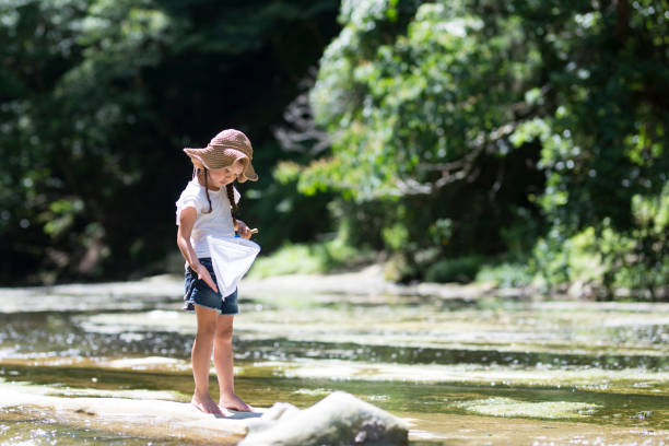 istock Little girl playing on a stream 920408774