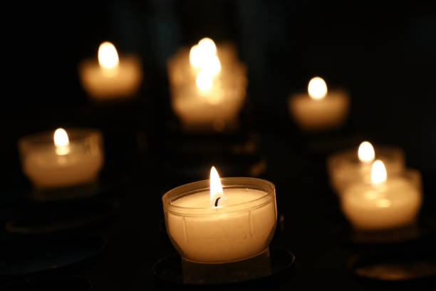 istock White candles burning in dark church close up 920409140