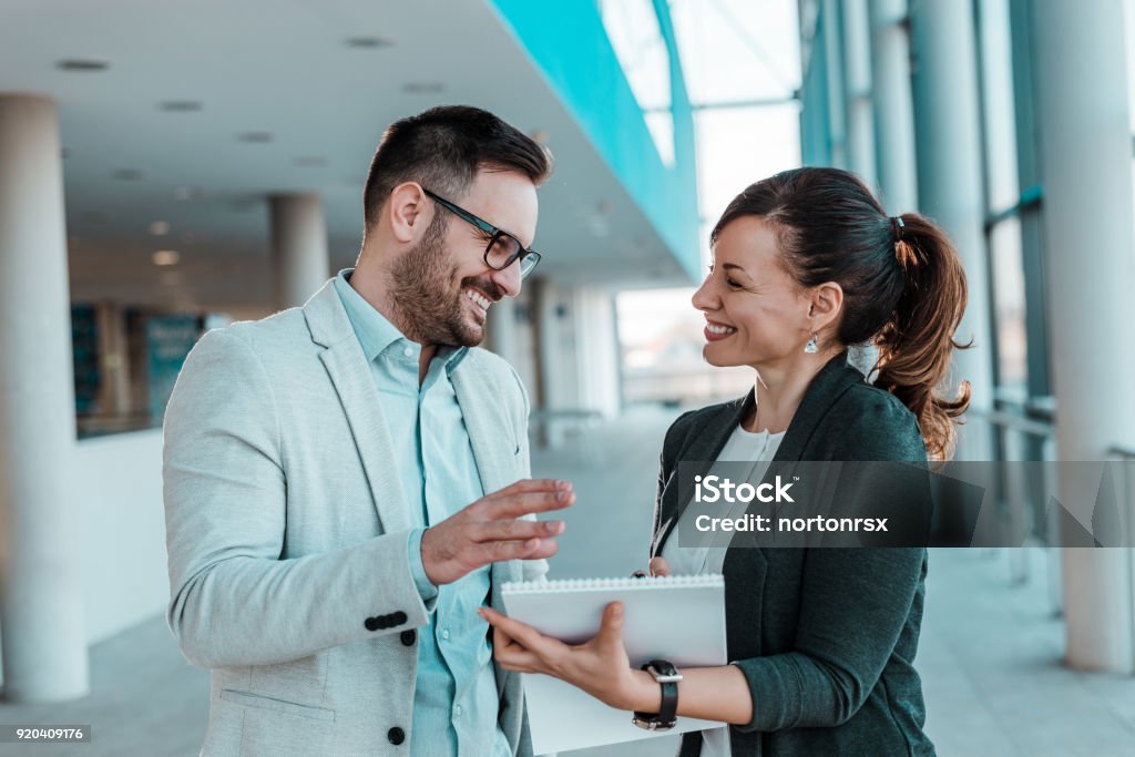 Smiling coworkers working together on new business project. Talking Stock Photo