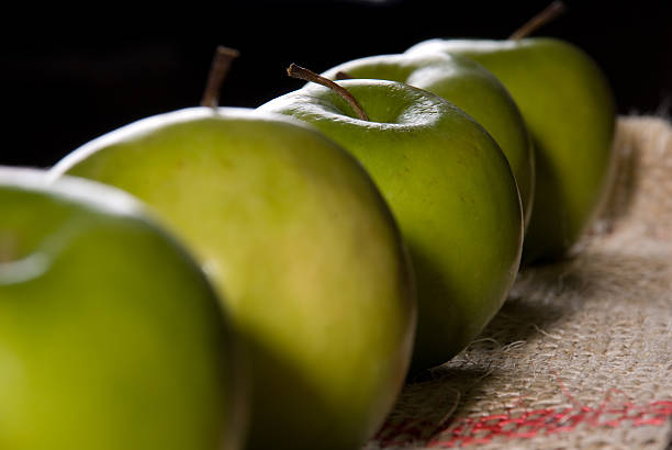 Green Apples in a Row stock photo