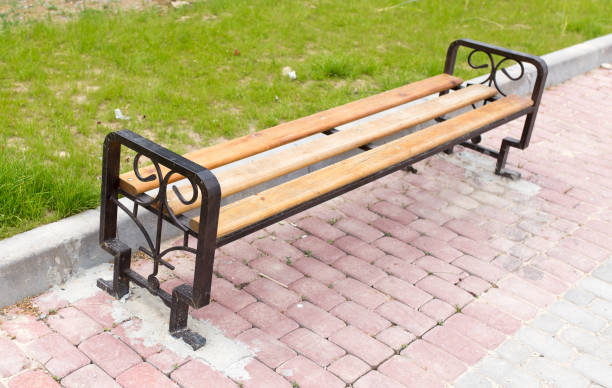 istock bench on the pavement in the park 920418202