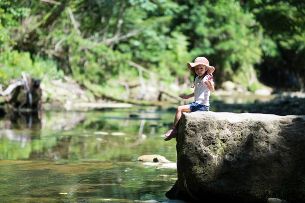 istock Little girl playing on a stream 920418510