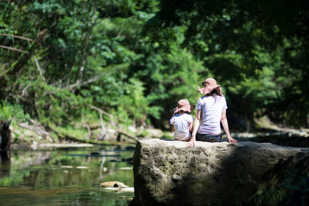 istock Mother and daughter playing in mountain stream 920418632