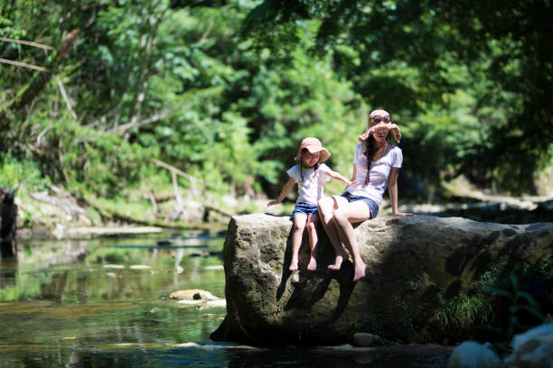 istock Mother and daughter playing in mountain stream 920418962