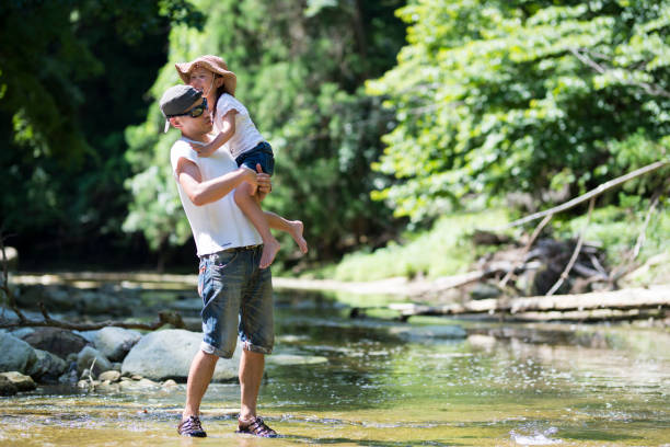 istock Father and daughter playing on mountain stream 920419042