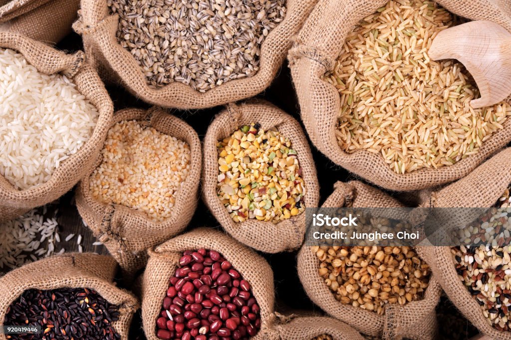 Various grains and cereals on market stall Various grains and cereals in sack on market stall. Top view. Legume Family Stock Photo